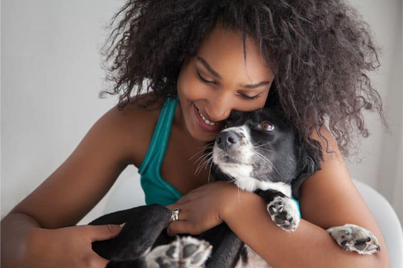 Auburn, CA Pet owner hugging dog.