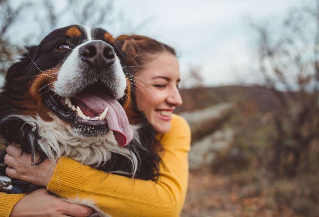 A woman hugging her dog.